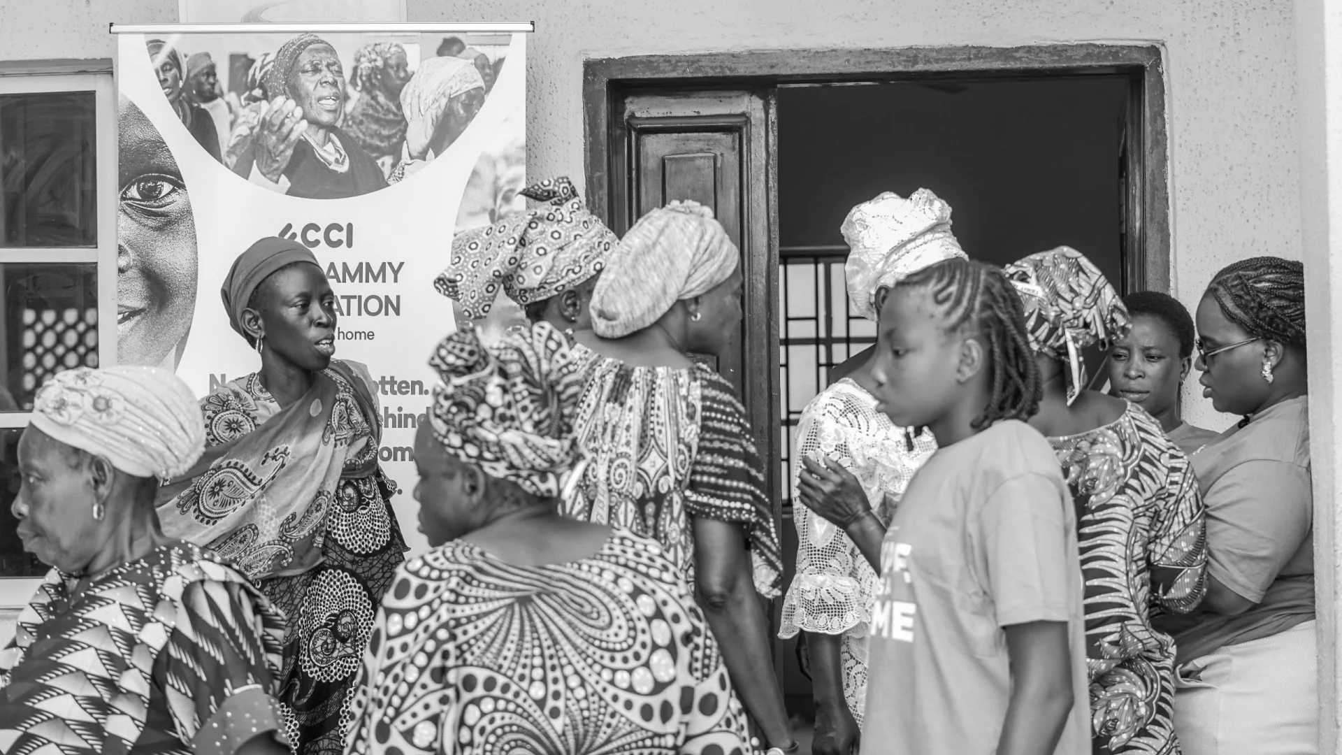 Women and Saintlammy Foundation team members speaking together during a Lagos community outreach